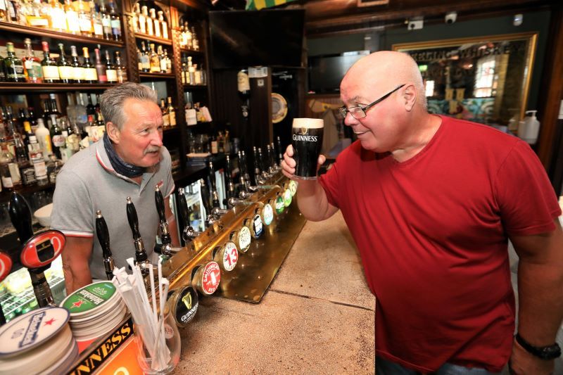 July 26, 2021: Customer Jim O Neill with a pint of Guinness with Dame Tavern owner Pat Wood in Dublin. (RollingNews.ie)