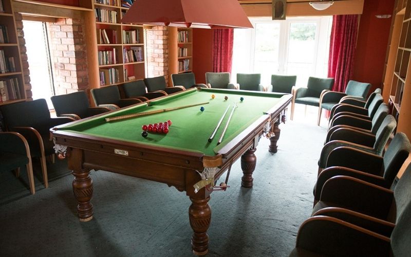 The exclusive snooker room lined floor to ceiling with books The exclusive snooker room lined floor to ceiling with books