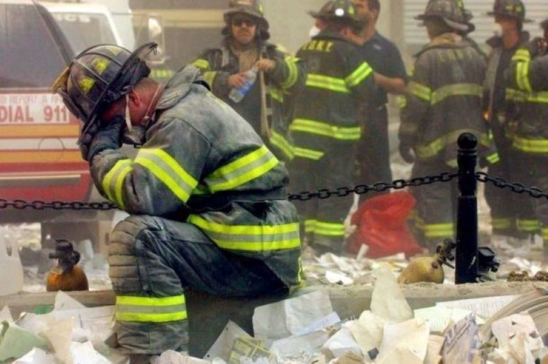 September 11, 2001: Firefighter Gerard McGibbon, of Engine 283 in Brownsville, Brooklyn, prays after the World Trade Center buildings collapsed. (Getty Images)
