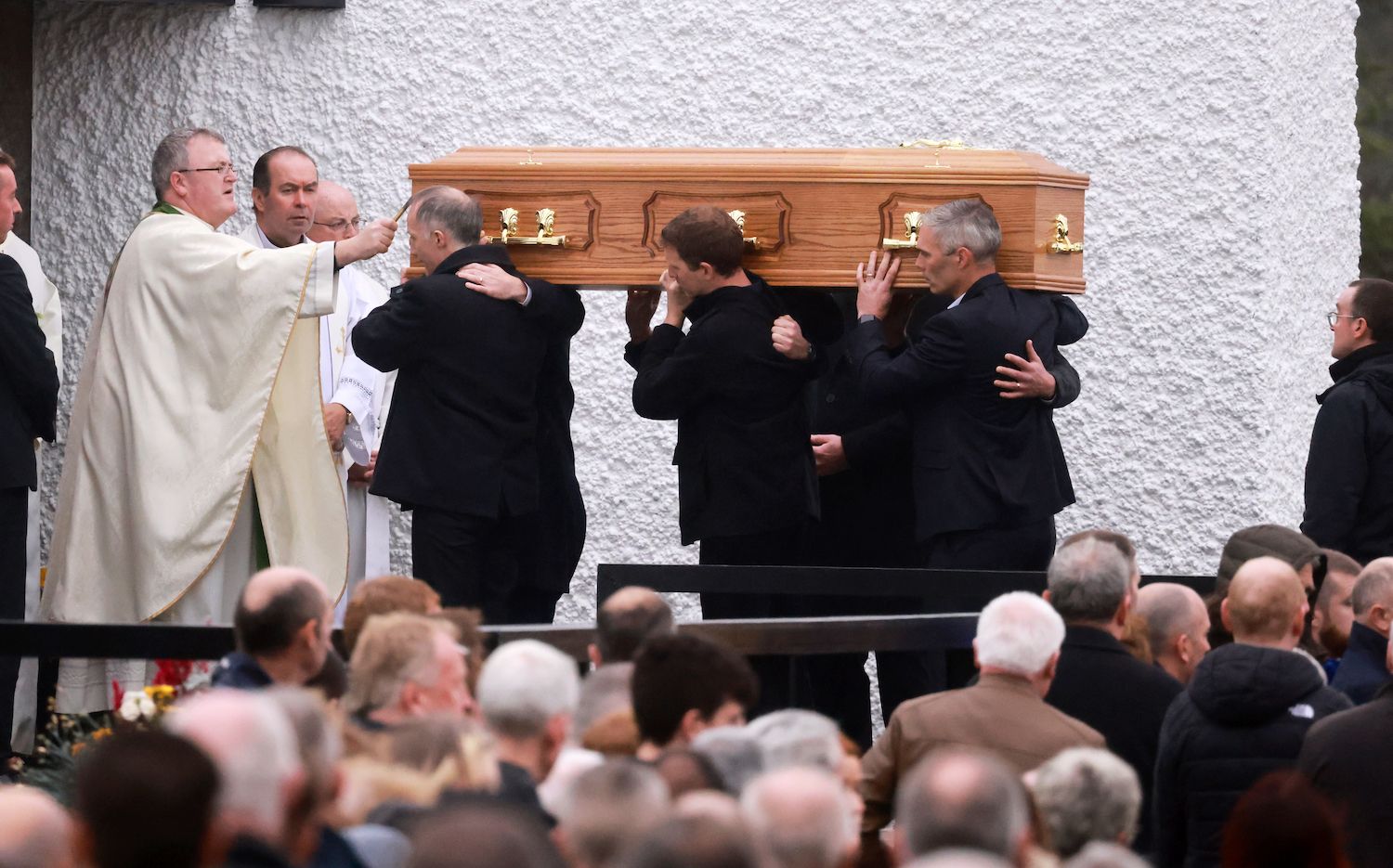 Father John Joe Duffy welcomes the coffin of Martin McGill, a victim of the tragic Creeslough explosion. Father John Joe Duffy welcomes the coffin of Martin McGill, a victim of the tragic Creeslough explosion.