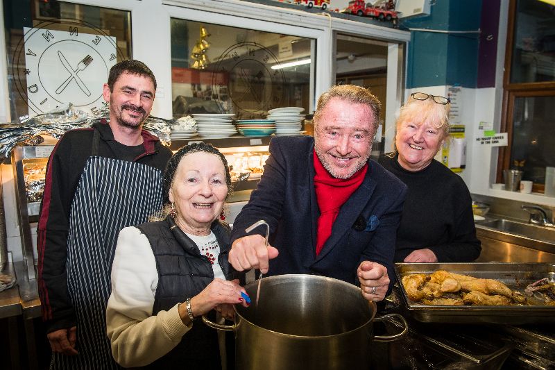 December 24, 2022: Michael Flatley with volunteers William Mulcahy, Patsy McCarthy, and Caitriona Twomey at Cork Penny Dinners on Christmas Eve. (RollingNews.ie) December 24, 2022: Michael Flatley with volunteers William Mulcahy, Patsy McCarthy, and Caitriona Twomey at Cork Penny Dinners on Christmas Eve. (RollingNews.ie)