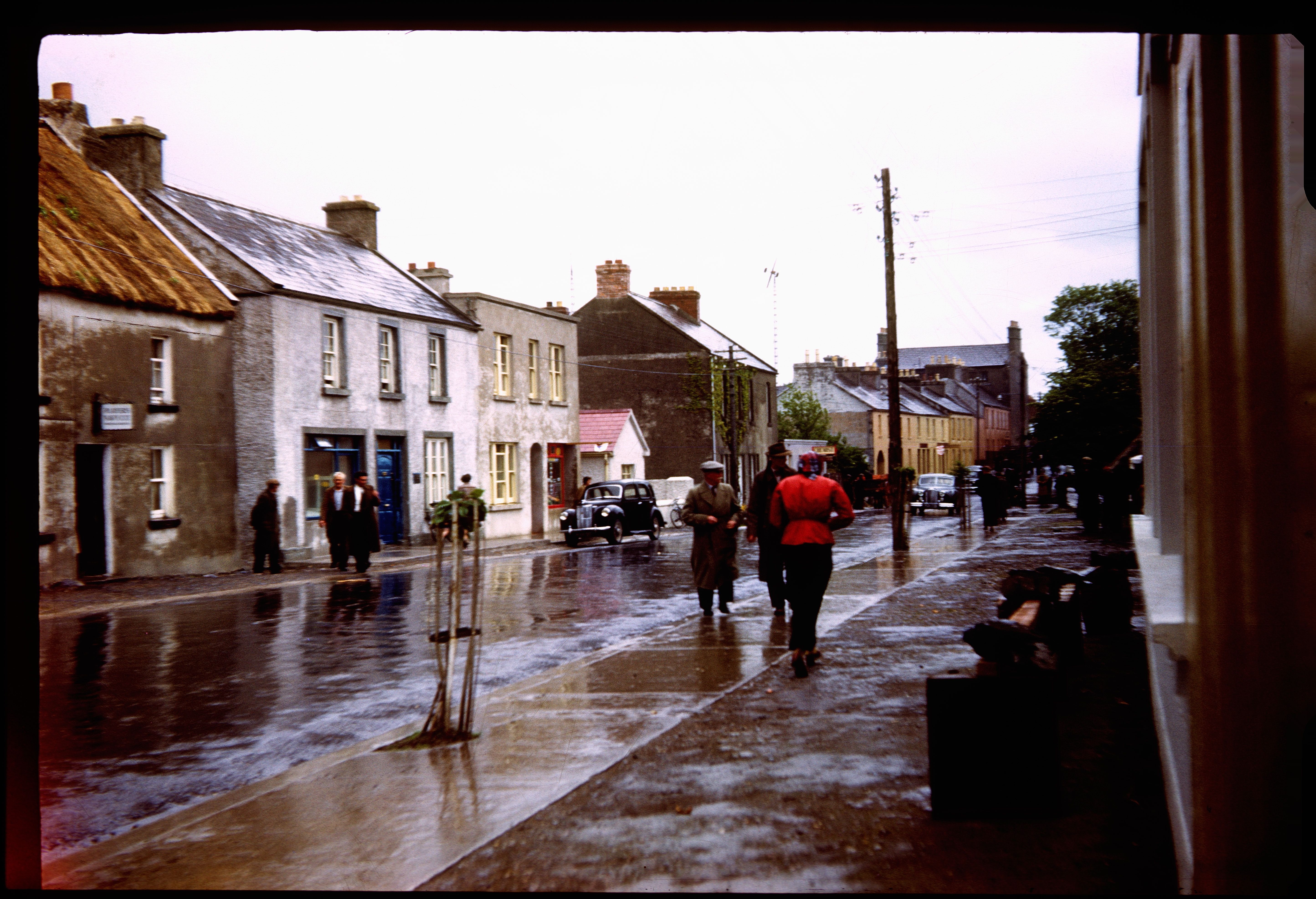 "Tour Bus made a short stop here. A small village near Galway. May 14, 1953." Photo Martin J. Walsh Jr, of Murdock Minnesota, Kodachrome.