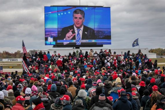 October 30, 2020: Supporters of US President Donald Trump watch a video featuring Fox host Sean Hannity ahead of Trump's arrival to a campaign rally at Oakland County International Airport in Waterford, Michigan. (Getty Images) October 30, 2020: Supporters of US President Donald Trump watch a video featuring Fox host Sean Hannity ahead of Trump's arrival to a campaign rally at Oakland County International Airport in Waterford, Michigan. (Getty Images)