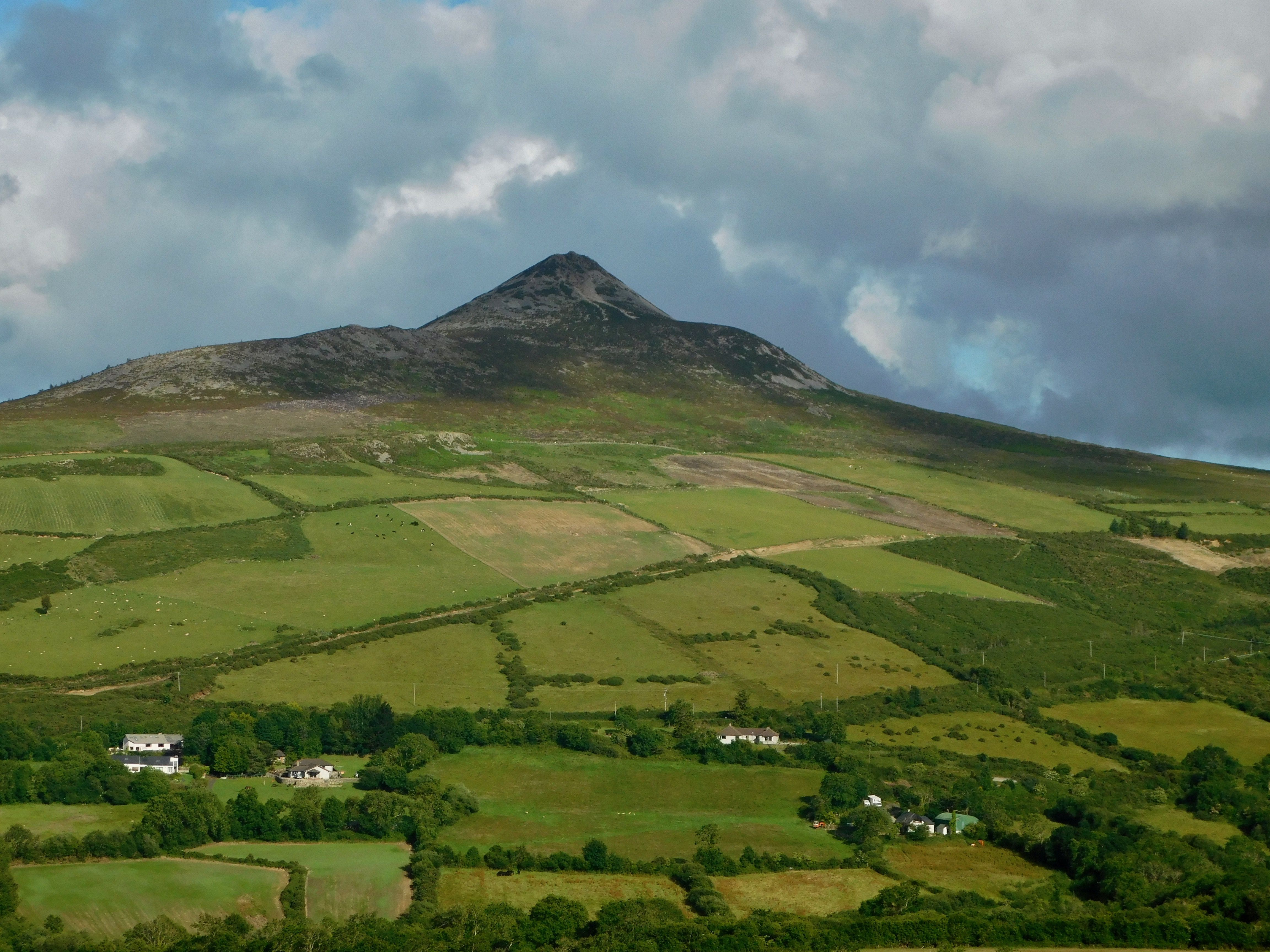 View of the Great Sugar Loaf Mountain in Wicklow County taken from Coolakay House B&B. How many "shades of green" can you count in this photo? View of the Great Sugar Loaf Mountain in Wicklow County taken from Coolakay House B&B. How many "shades of green" can you count in this photo?