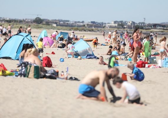 People take in the sun on Burrow Beach in Co. Dublin during a heatwave in 2022. ROLLINGNEWS.IE