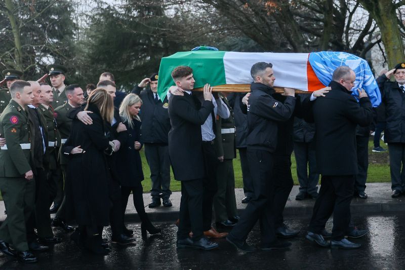 December 22, 2022: Mourners and members of the Defence Forces as the coffin of Pte Seán Rooney is carried to Holy Family Church, Dundalk. (RollilngNews.ie) December 22, 2022: Mourners and members of the Defence Forces as the coffin of Pte Seán Rooney is carried to Holy Family Church, Dundalk. (RollilngNews.ie)