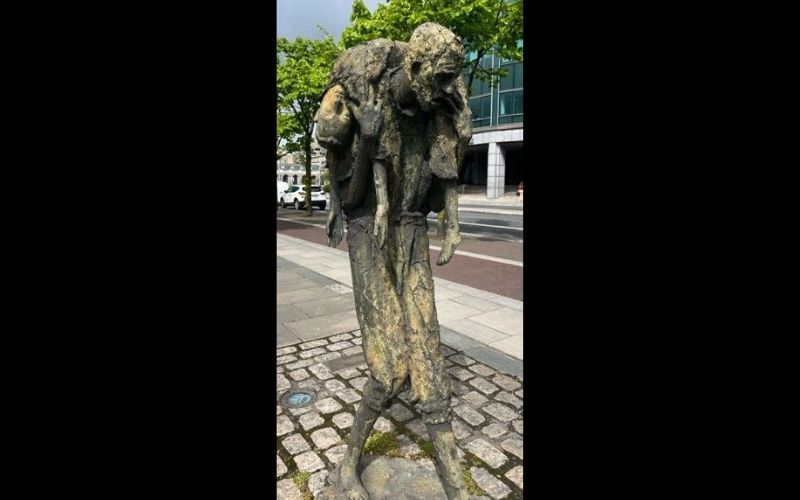 Man carrying a dead child in Rowan Gillespie's Famine sculpture on the quays in Dublin. Man carrying a dead child in Rowan Gillespie's Famine sculpture on the quays in Dublin.