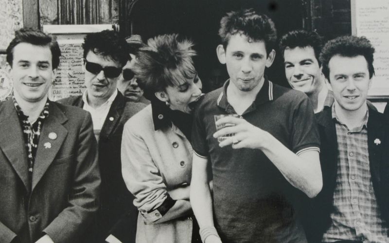 The Pogues, with original bassist Cait O’Riordan biting the shoulder of Shane MacGowan, frontman and main songwriter with The Pogues