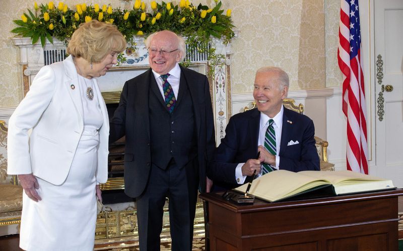 Biden signs the visitor's book at Áras an Uachtaráin. Getty