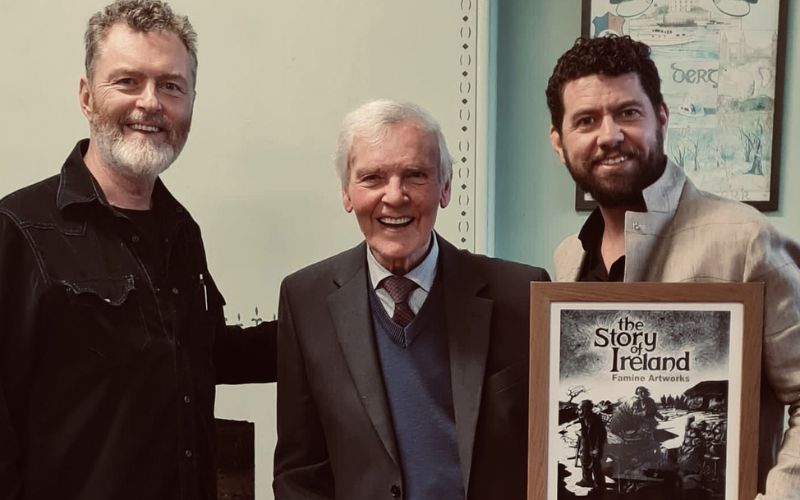David Rooney, his father Joe Rooney, and author/singer/songwriter Declan O'Rourke at the launch of Rooney's Famine Artwork exhibition when it found a permanent home at the Irish Workhouse Center in Portumna, County Galway in August 2022. (Suzanne Bach) David Rooney, his father Joe Rooney, and author/singer/songwriter Declan O'Rourke at the launch of Rooney's Famine Artwork exhibition when it found a permanent home at the Irish Workhouse Center in Portumna, County Galway in August 2022. (Suzanne Bach)