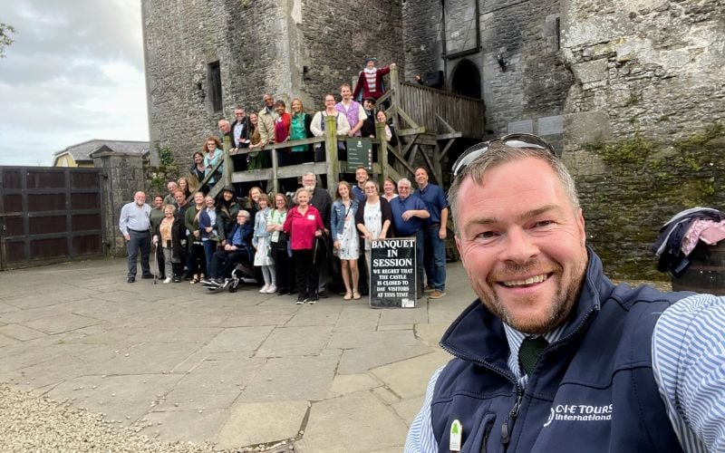 One of CIE Tours’ expert Tour Directors, Chris Whyte, with happy guests exploring some of Ireland’s most beloved landmarks – on the Taste of Ireland tour.