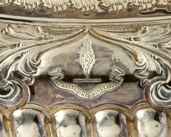 A close up of the engraving on the tea set, which reads “Fortitudine Vincimus” (“Through endurance, we conquer”). Photo: Roseberys