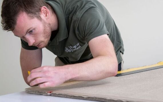Hand applying our Irish twill linen backing to a rug Hand applying our Irish twill linen backing to a rug