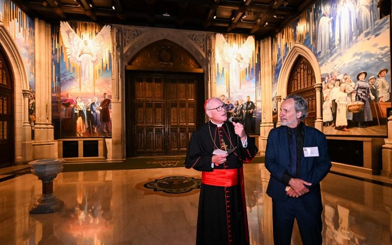 Cardinal Timothy Dolan, Archbishop of New York, with artist Adam Cvijanovic, unveils a new mural painted by Cvijanovic at St. Patrick’s Cathedral on Wednesday, Sept. 17, 2025, in New York. The mural, which is the largest permanent artwork commissioned for the cathedral in its 146-year history, celebrates the 1879 Apparition at Knock, Ireland, the faith of generations of immigrants to New York, and the service of New York City’s first responders. (Diane Bondareff/AP Content Services for the Archdiocese of New York) Cardinal Timothy Dolan, Archbishop of New York, with artist Adam Cvijanovic, unveils a new mural painted by Cvijanovic at St. Patrick’s Cathedral on Wednesday, Sept. 17, 2025, in New York. The mural, which is the largest permanent artwork commissioned for the cathedral in its 146-year history, celebrates the 1879 Apparition at Knock, Ireland, the faith of generations of immigrants to New York, and the service of New York City’s first responders. (Diane Bondareff/AP Content Services for the Archdiocese of New York)