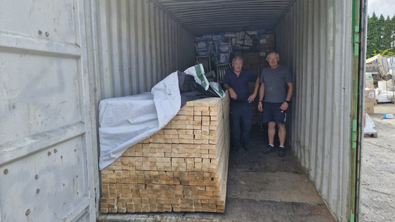 Pat Barry and Dan Ducey of Project ESPWA pictured ahead of a shipment of building materials ahead of its departure for Kenya. (Credit: CIR.)