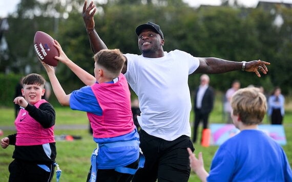 NFL player Efe Obada with students from Kingswood Community College in Dublin during an NFL Flag Football clinic to announce the NFL Flag Kickoff initiative in post-primary secondary schools in Ireland. (Brendan Moran/Sportsfile)