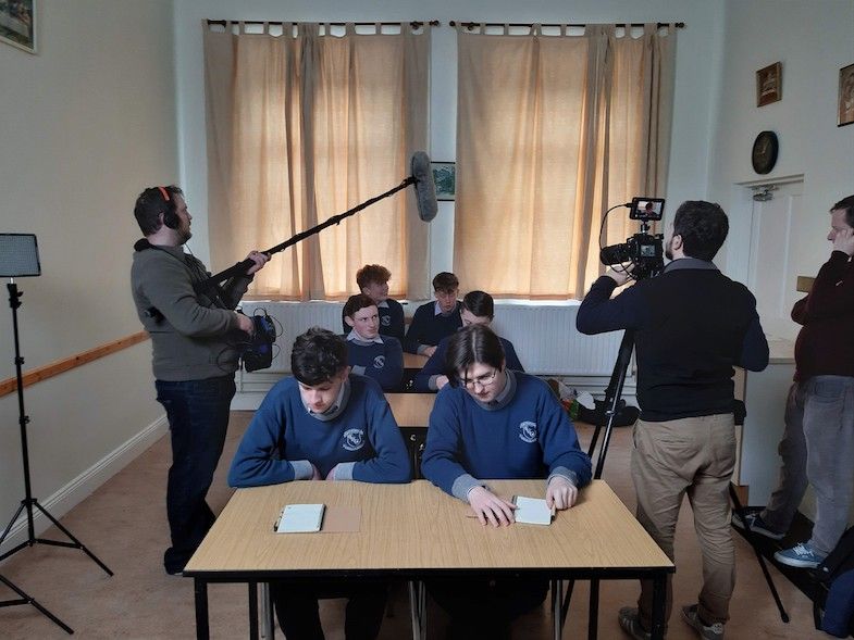 Filming the students for the postal service exam.