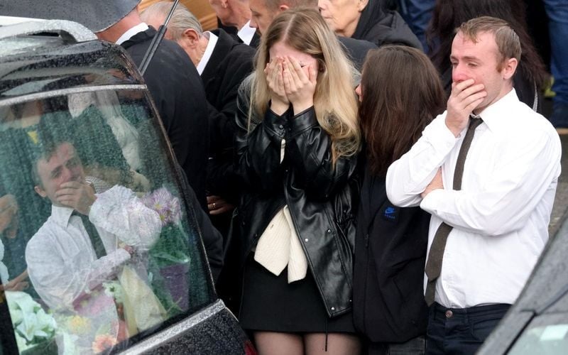 Mourners outside the funeral of the English family in Waterford.