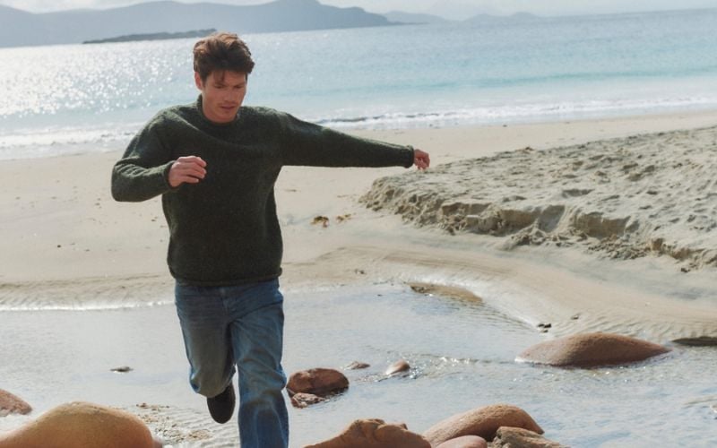 The Raheen green roll neck sweater from Aran Woollen Mill.