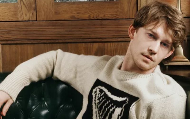 Joe Alwyn wears the Guinness Shield Harp jumper, €950, and the Guinness towelling shorts, €490, Guinness x JW Anderson collection