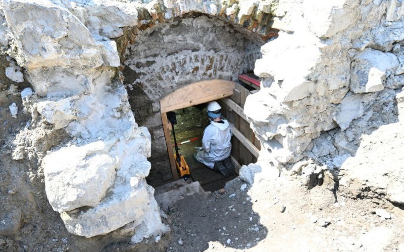 A member of the Forensic excavation team working in the subterranean vaulted structure. (ODAIT)