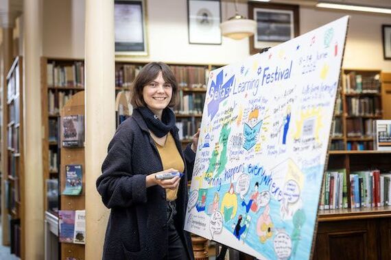 Illustrator Stephanie Henkman pictured with her live illustration produced during the launch event for Belfast Learning Festival 2026.