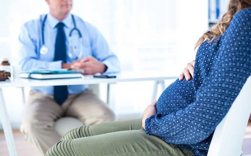 Pregnant woman with male doctor. Credit: iStock