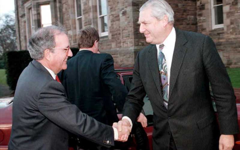 US Senator George Mitchell greets Northern Ireland Secretary of State Sir Patrick Mayhew on his arrival at Stormont in December 1995. Credit: ALAN LEWIS/AFP/Getty Images