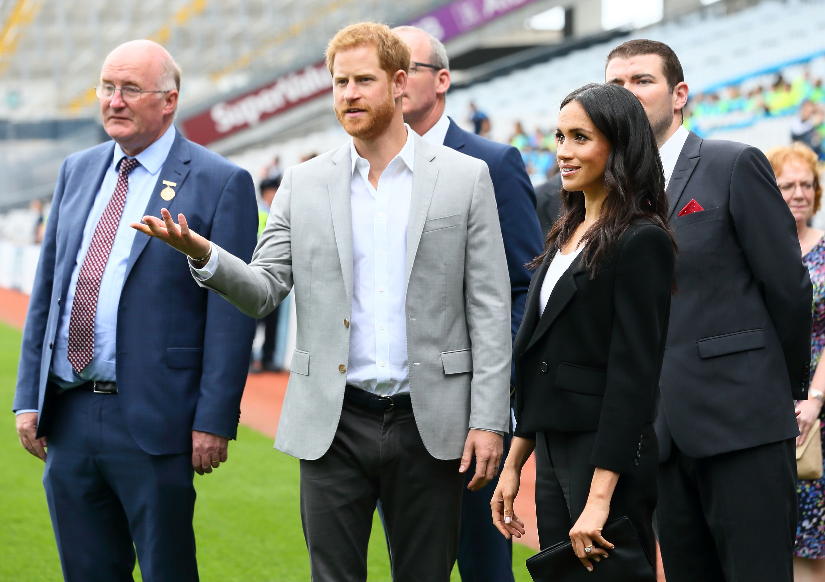 GAA President John Horan (L) and Britain's Prince Harry and wife Meghan, Duke and Duchess of Sussex visit Croke Park in Dublin on July 11, 2018 during their two day visit. Markle was presented with documents detailing her Irish ancestry. (Photo FRANK MCGRATH/AFP/Getty Images)