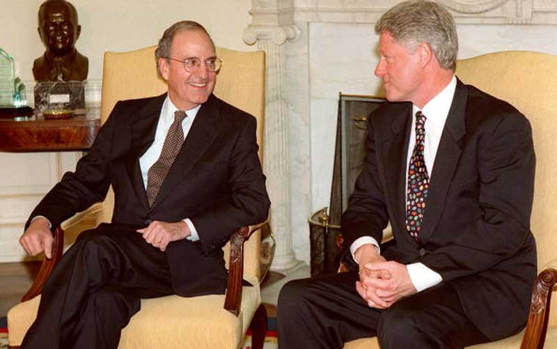 US President Bill Clinton and former senator George Mitchell in the Oval Office in April 1998. Credit: PAUL J. RICHARDS/AFP/Getty Images