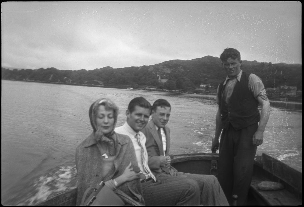 Joseph P. Kennedy, Jr. (second from left) sits aboard a motor boat with an unidentified woman and boy in Ireland, during a Kennedy family trip; an unidentified man (standing) operates the outboard motor at right. Photographer unknown. Copyright John F. Kennedy Library Foundation. Kennedy Family Collection. John F. Kennedy Presidential Library and Museum, Boston