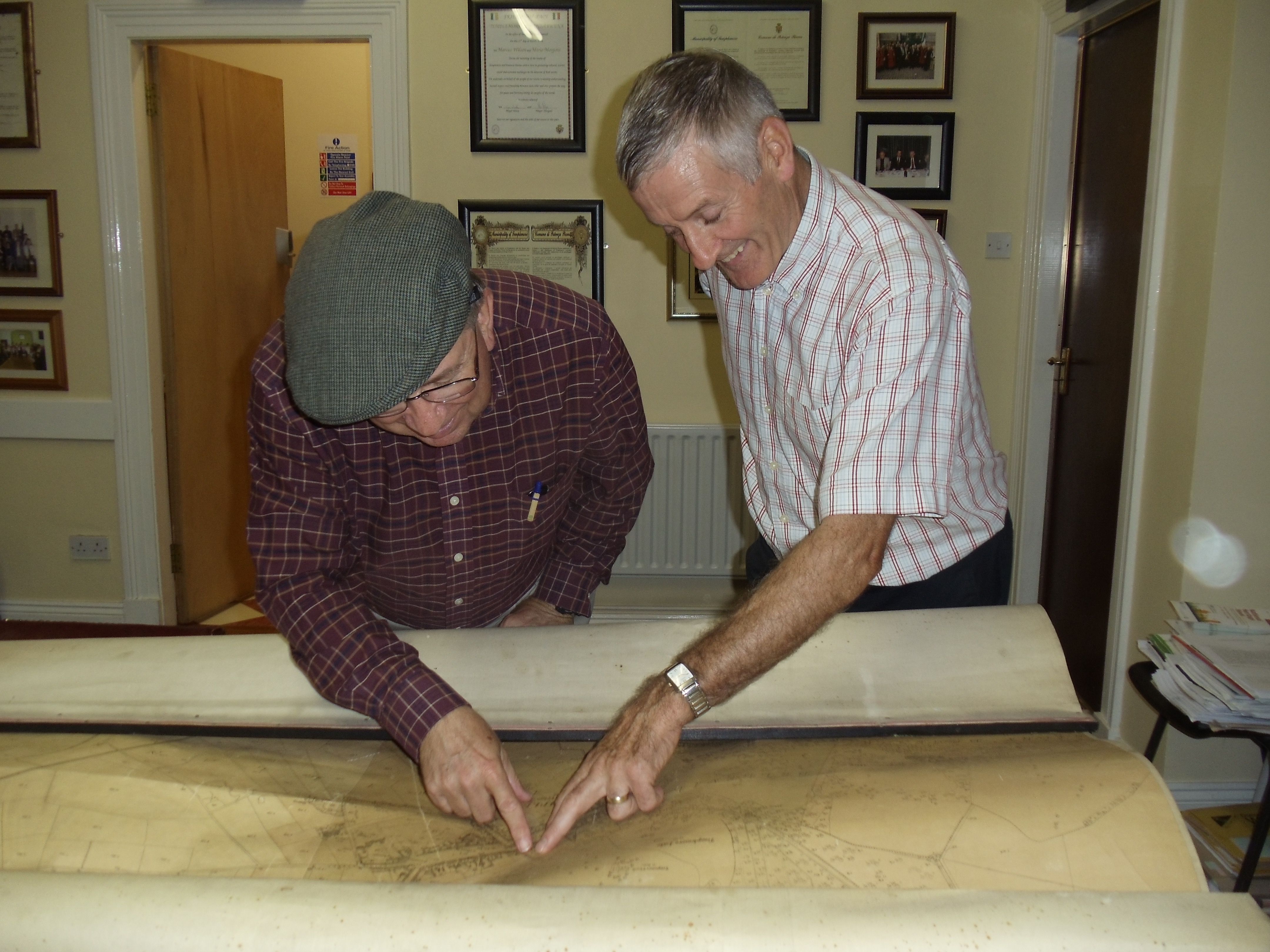 Mike (left) and staff member in Templemore City Hall share a laugh after finding Pig Foot Lane on a land map from the early 1800s.
