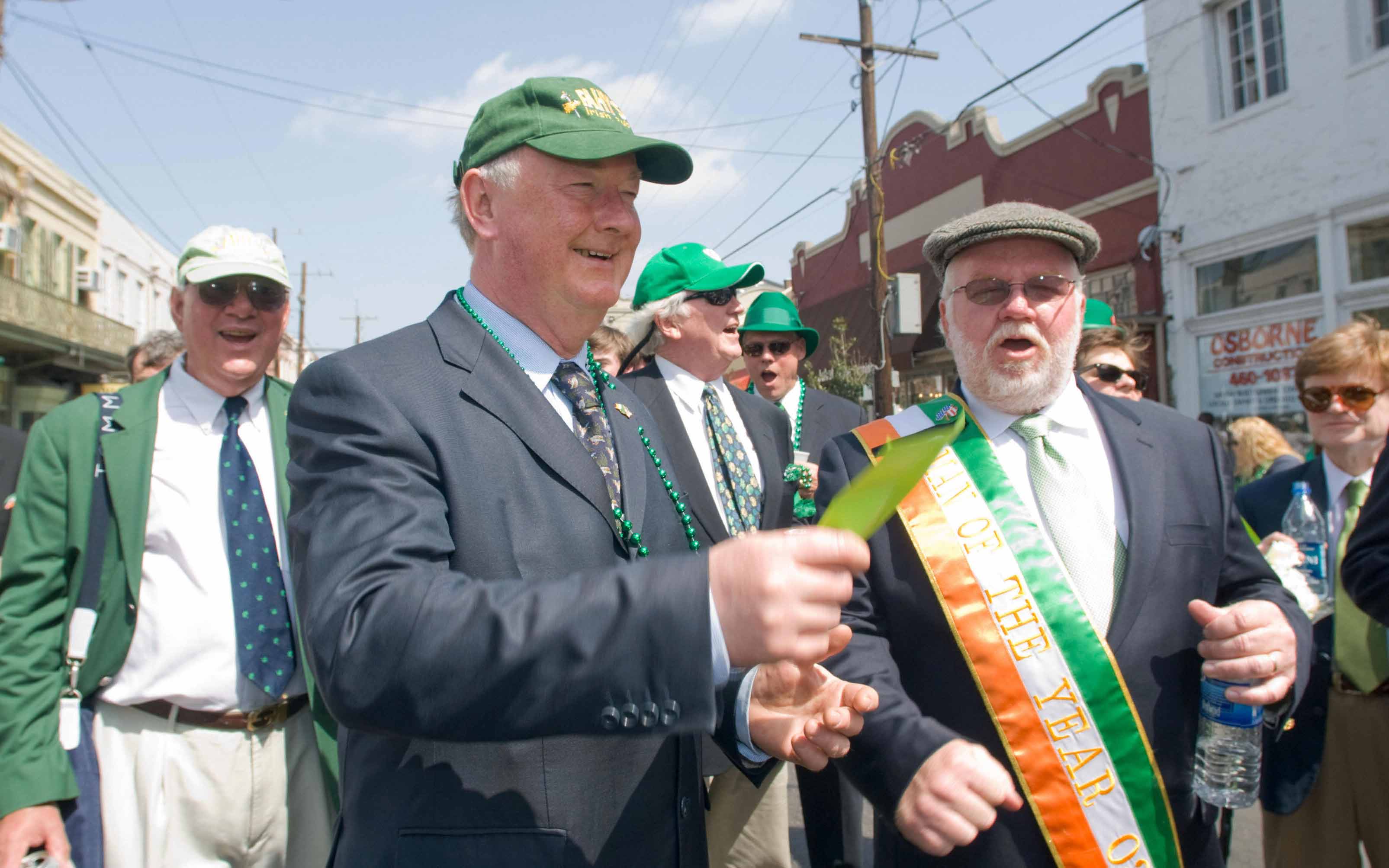Former Irish parliament speaker John O'Donoghue (C) sings with the Ancient Order of Hibernians in America while marching down Magazine Street during the 61th Annual Irish Channel Mass and Parade celebration on St. Patrick's Day on March 15, 2008 through the Irish Channel neighborhood of New Orleans. AFP PHOTO/Matthew HINTON