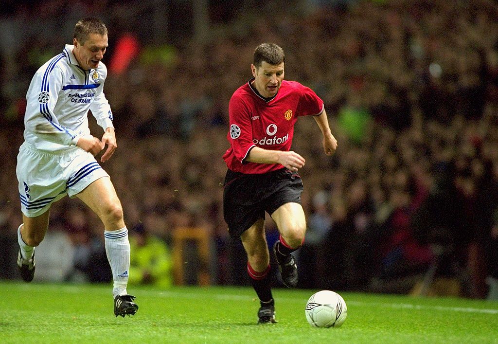 Denis Irwin of Manchester United takes the ball past Aliaxandr Khatskevitch of Dynamo Kiev during the UEFA Champions League match played at Old Trafford, in Manchester, England. Manchester United won the match 1-0. Credit: Ben Radford /Allsport