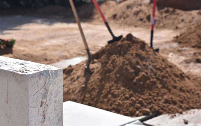 A woman was visiting her parents' burial plot when she was swallowed by a sinkhole.