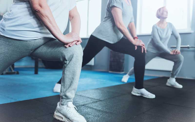 Elderly group lunging at fitness club. Credit: iStock