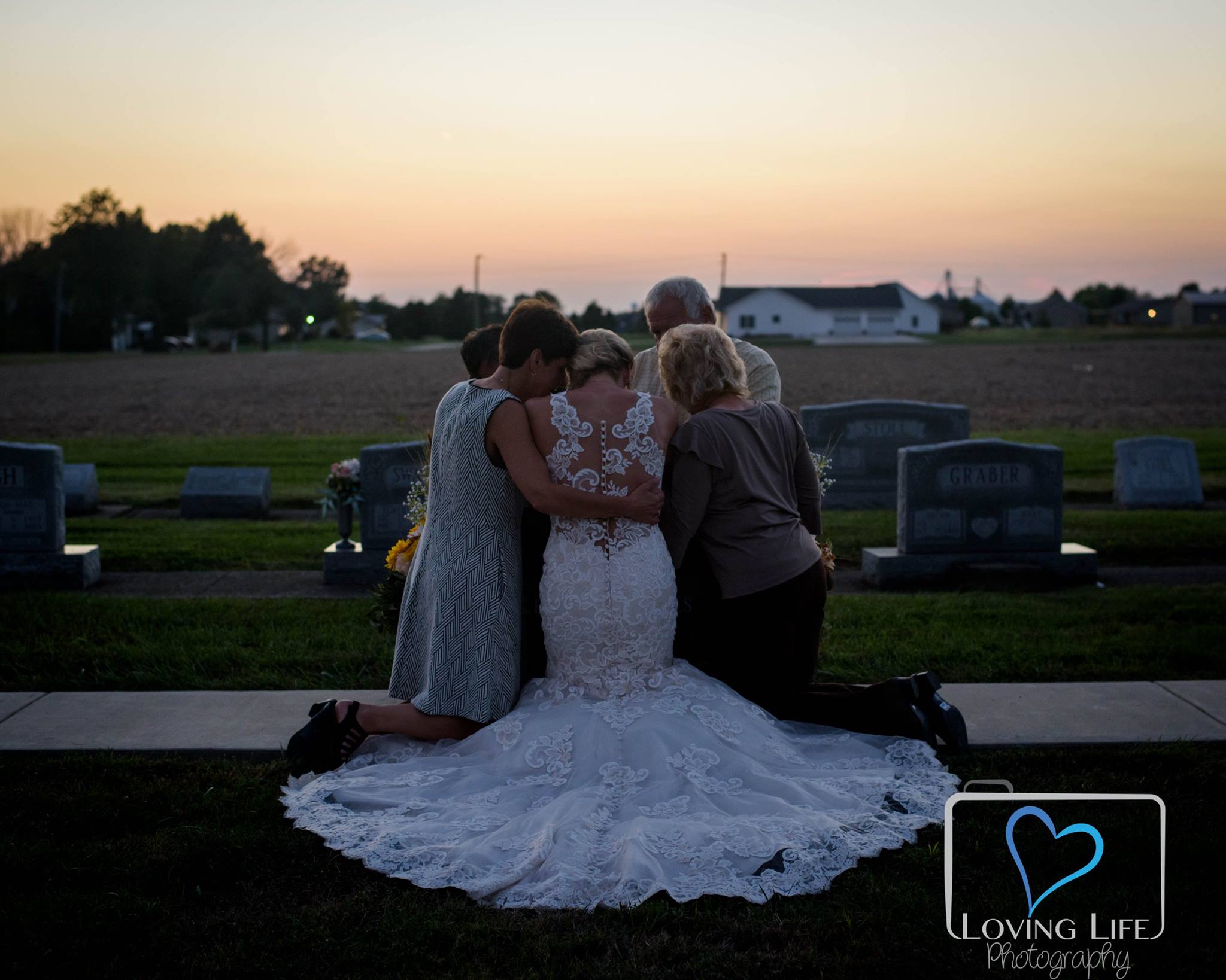 Family gathers at Murphy's grave (Loving Life Photography Facebook)