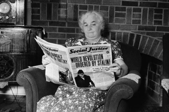A woman reading a copy of 'Social Justice', the magazine founded by the radical, anti-semitic priest Father Charles Coughlin, in her home in Royal Oak, Michigan, where Father Coughlin is a parish priest. (Photo by Arthur Siegel/Getty Images)