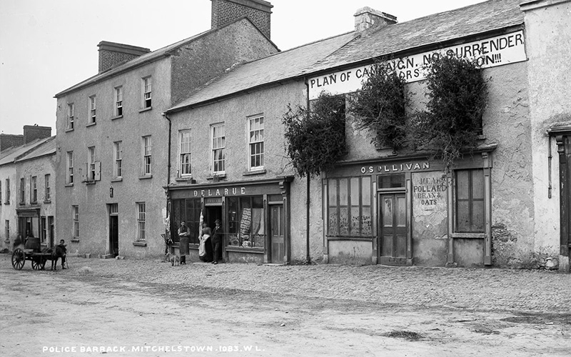 A building in Mitchelstown bears an anti-eviction banner and has its windows barricaded with brush to repel attacks. IMAGE: NATIONAL LIBRARY OF IRELAND