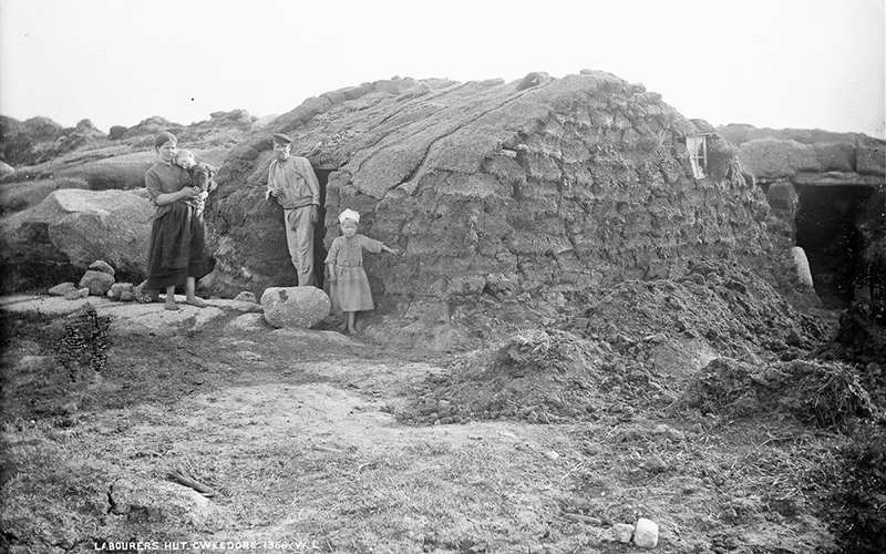 A laborer's family outside their temporary turf hut after being evicted from their home. IMAGE: NATIONAL LIBRARY OF IRELAND