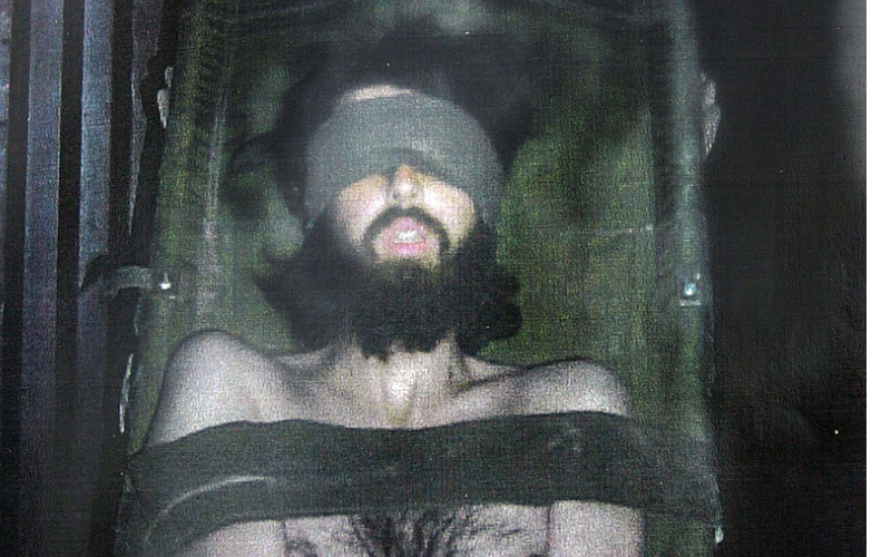 American Taliban John Walker Lindh is shown in this undated photo bound to a stretcher after his capture by U.S. troops at Camp Rhino in Khandahar, Afghanistan. This image is a copy of a photo released by Lindh's defense lawyers after a discovery hearing April 1, 2002, in the U.S. court in Alexandria, VA. (Photo by Getty Images)