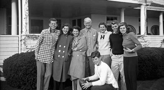 From left: John, Jean, Rose, Joseph, Patricia, Robert, Eunice and Ted (kneeling, middle) pose in front of a house in Hyannis Port. Credit: Kennedy Presidential Library and Museum