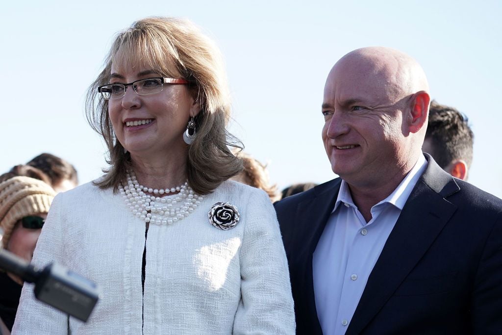 Former U.S. Rep. Gabrielle Giffords (D-AZ) (L) and her husband, retired Navy combat veteran and NASA astronaut Mark Kelly (R), participate in a news conference on gun control March 23, 2018, on Capitol Hill in Washington, DC. (Photo by Alex Wong/Getty Images)