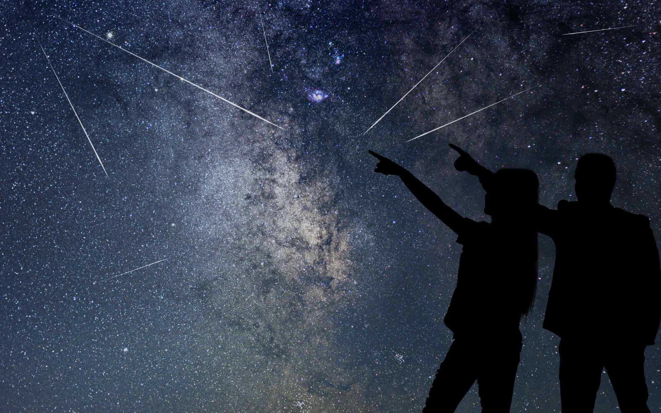 Silhouette of young couple watching Meteor Shower. Image: Getty.