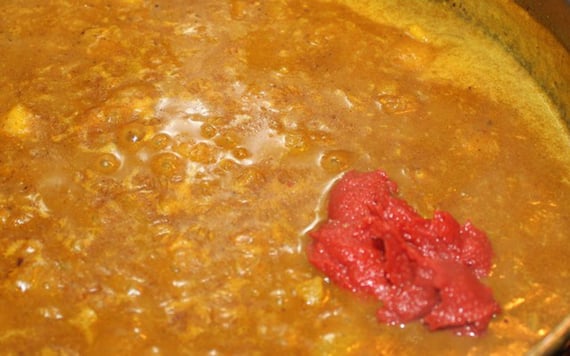 A hint of sweetness is next. Add the tomato paste and two teaspoons of sugar.