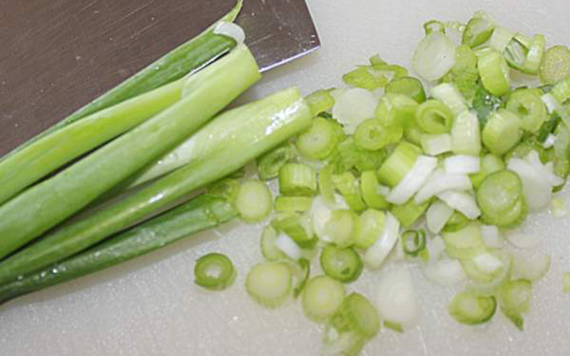 Cutting up spring onions, fine, for your egg salad sandwiches.