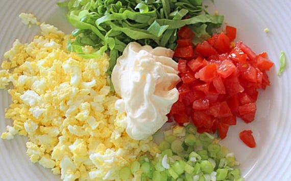 All the delicious fresh ingredients for your egg salad sandwiches in a bowl.