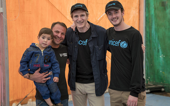Liam Neeson and his son Michael visit a refugee camp in Jordan.