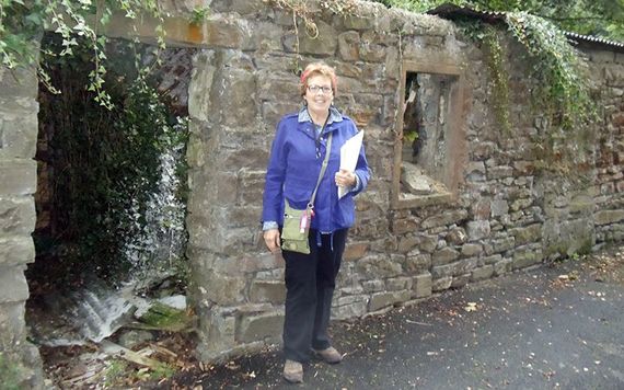 Kate standing in front of the ruins of one room stone hovels that lined Pig Foot Lane in Templemore, Co. Tipperary where her great grandmother Mary Waters lived when she was baptized in 1831.