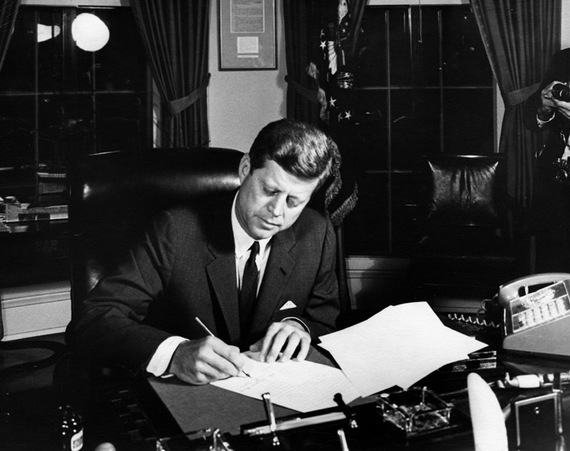 Kennedy signing the order for the blockade of Cuba.